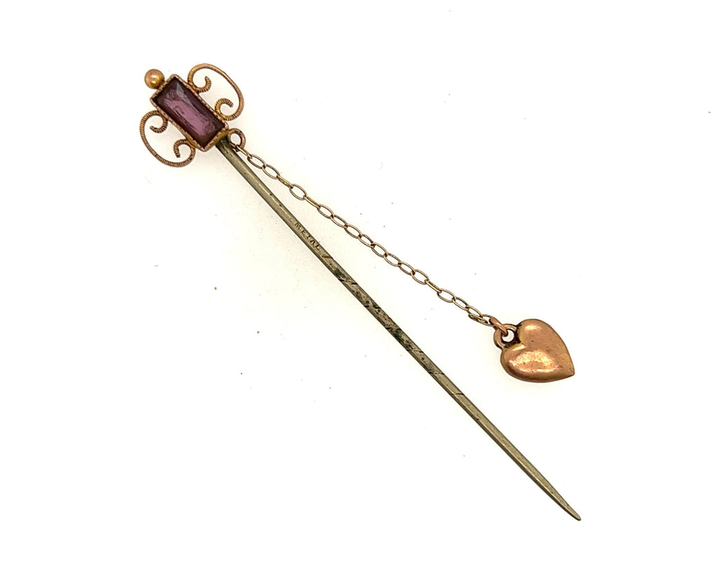 9ct yellow gold glass top and chain attached heart on a base metal pin. 